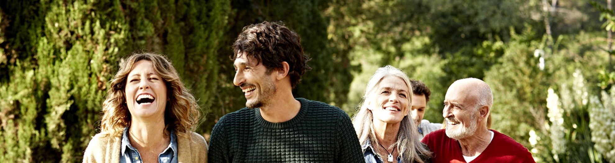 Happy multi-generation family holding hands while walking in park
